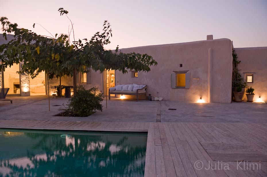 Classic island terrace with swimming pool at night time